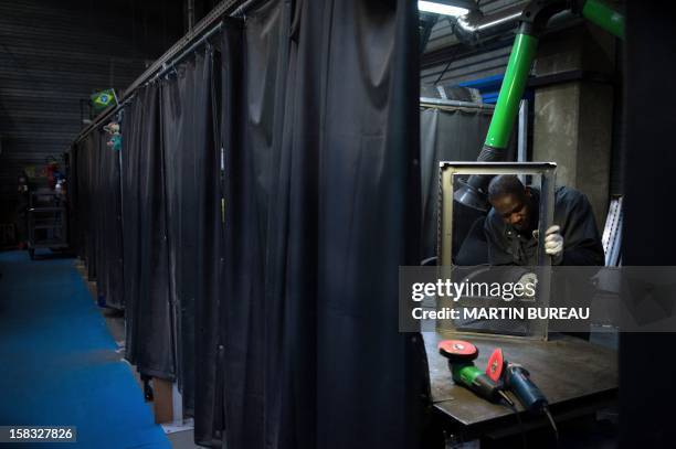 An employee of French cooker maker "La Cornue" works in the factory on December 13 in Saint-Ouen-l'Aumone, north of Paris. AFP PHOTO / MARTIN BUREAU