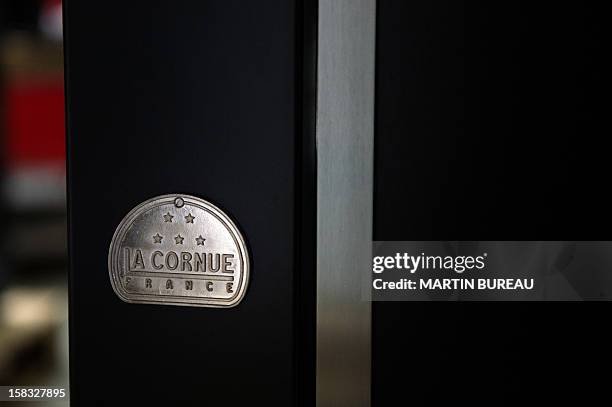 View of French cooker maker "La Cornue's" logo is pictured in the factory on December 13 in Saint-Ouen-l'Aumone, north of Paris. AFP PHOTO / MARTIN...