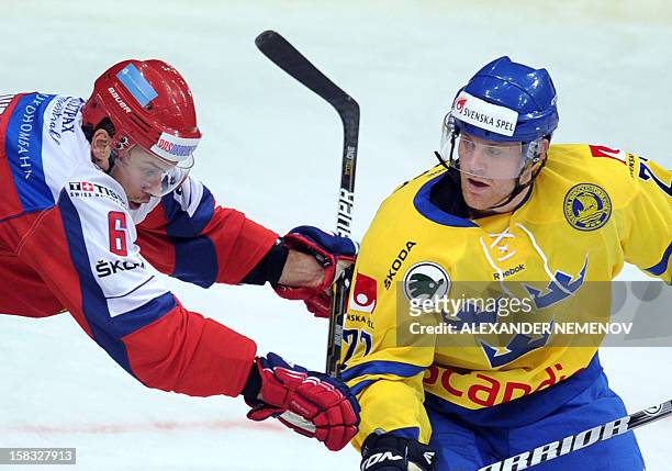 Sweden's Patric Hornqvist vies with Russia's Denis Denisov during Channel One Cup hockey match, the event of the Euro Hockey Tour in Moscow on...