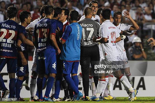 Lucas of Brazil's Sao Paulo reacts to players of Argentine's Tigre at the end of the first half of their Copa Sudamericana football final match at...