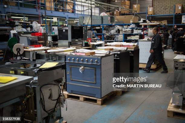 Employees of French cooker maker "La Cornue" work in the factory on December 13 in Saint-Ouen-l'Aumone, north of Paris. AFP PHOTO / MARTIN BUREAU