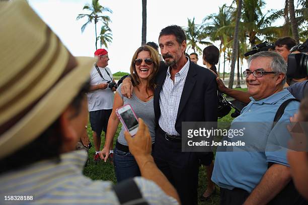 John McAfee interacts with people after speaking to reporters outside of the Beacon Hotel where he is staying after arriving last night from...