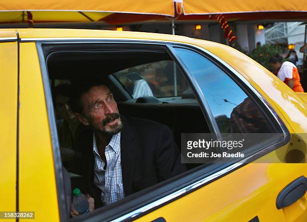 John McAfee sits in a cab in front of the Beacon Hotel where he is staying after arriving last night from Guatemala on December 13, 2012 in Miami...