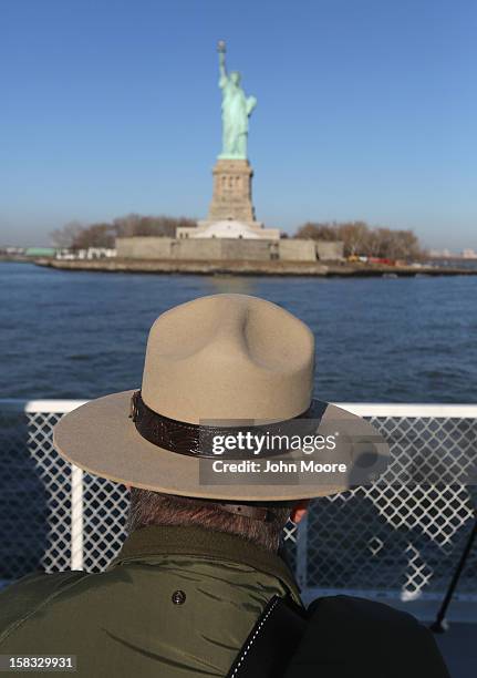 National Park Service ranger looks towards the Statue of Liberty which, remains closed to the public six weeks after Hurricane Sandy on December 13,...