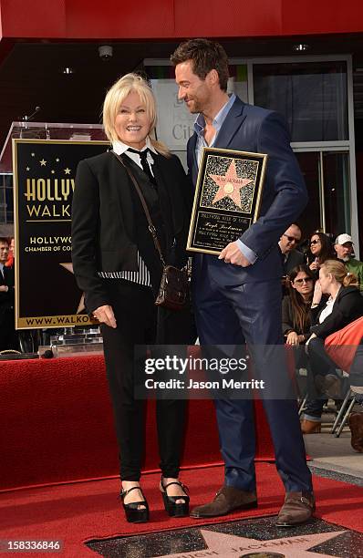 Actor Hugh Jackman and his wife Deborra-Lee Furness pose as Hugh Jackman is honored with a star on The Hollywood Walk Of Fame on December 13, 2012 in...