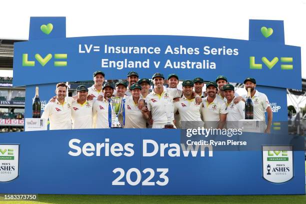 Pat Cummins of Australia lifts the Ashes Urn alongside teammates following Day Five of the LV= Insurance Ashes 5th Test Match between England and...