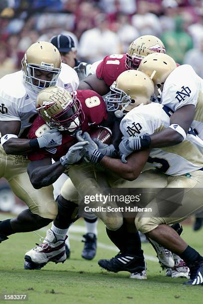 Notre Dame defenders swarm running back Greg Jones of Florida State on October 26, 2002 at Doak Campbell Stadium in Tallahassee, Florida. Notre Dame...