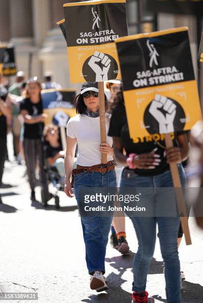 Lucy Liu joins SAG-AFTRA members as they maintain picket lines across New York City during strike on July 31, 2023 in New York City.
