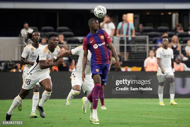 Ousmane Dembélé of FC Barcelona heads the ball during the first half of the pre-season friendly match against Real Madrid at AT&T Stadium on July 29,...