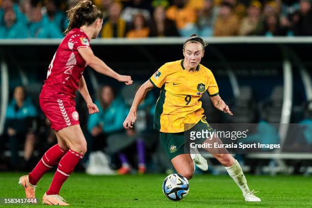 Caitlin Foord of Australia dribbles Janni Thomsen of Denmark during the FIFA Women's World Cup Australia & New Zealand 2023 Round of 16 match between...