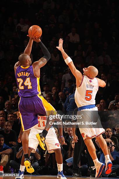 Kobe Bryant of the Los Angeles Lakers shoots against Jason Kidd of the New York Knicks on December 13, 2012 at Madison Square Garden in New York...