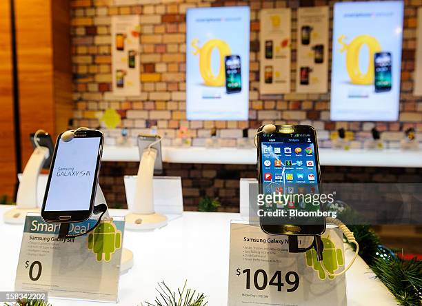 Samsung Electronics Co.'s Galaxy S III, left, and Note II smartphones are displayed at a Telecom Corp. Of New Zealand retail outlet in Wellington,...