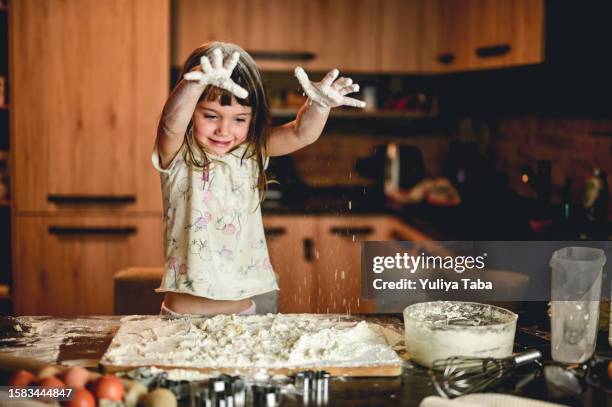 playful little girl playing in the kitchen. - messy kid stock pictures, royalty-free photos & images