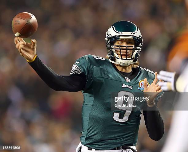 Nick Foles of the Philadelphia Eagles passes under pressure from Robert Geathers of the Cincinnati Bengals on December 13, 2012 at Lincoln Financial...
