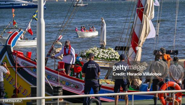 The Pilgrim Image of Our Lady of Fatima sails the Tagus River onboard a traditional barge into Terreiro do Paço dock on July 31, 2023 in Lisbon,...