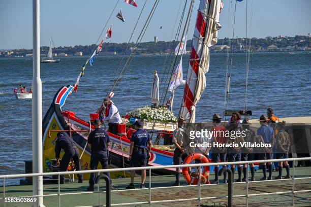 The Pilgrim Image of Our Lady of Fatima sails the Tagus River onboard a traditional barge into Terreiro do Paço dock on July 31, 2023 in Lisbon,...