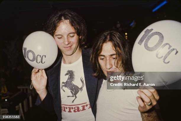 English musicians Eric Stewart and Lol Creme of rock band 10cc holding promotional balloons in New York, October 1975.