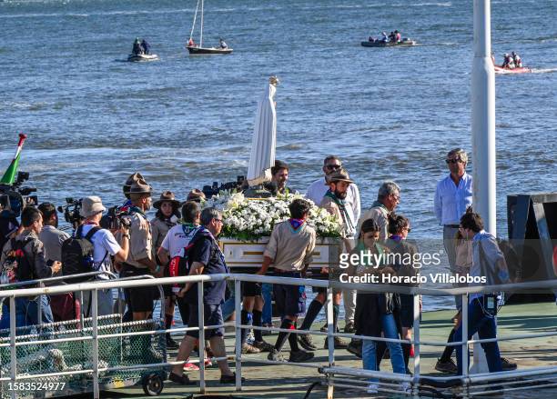 The Pilgrim Image of Our Lady of Fatima is being carried by Boy Scouts after sailing the Tagus River onboard a traditional barge into Terreiro do...