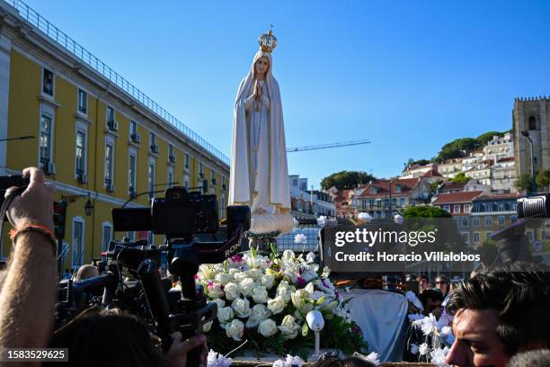 Visual journalists surround the Pilgrim Image of Our Lady of Fatima sitting atop of a truck and escorted Boy Scouts after having sailed the Tagus...