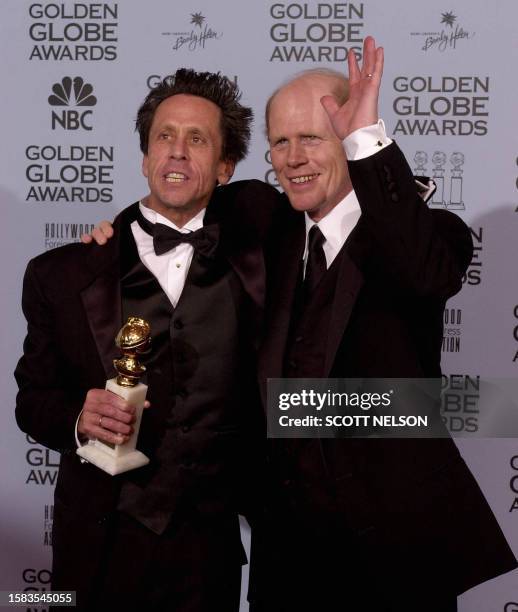 Producer Brian Grazer and director Ron Howard wave to photographers as Grazer holds his Golden Globe award for Best Motion Picture-Drama for the...