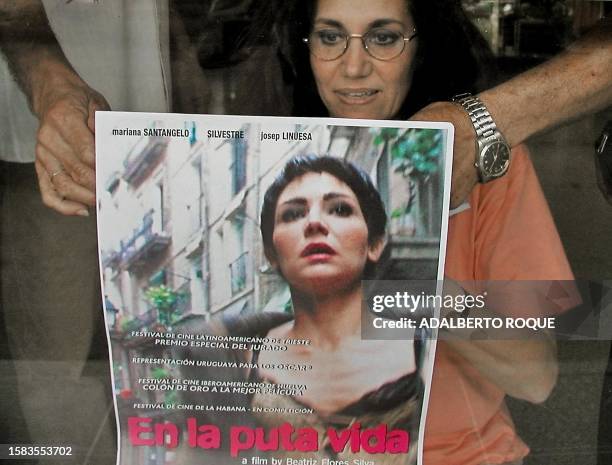 Uruguayan film director Beatriz Flores Silva is seen pasting a poster of her latest film in La Habana, Cuba 05 December 2001. La realizadora...