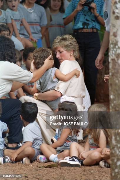 Princess Diana of Wales talks with Brazilian children on April 23, 1991 at Carajas during the British Royal's official visit. On an official trip to...