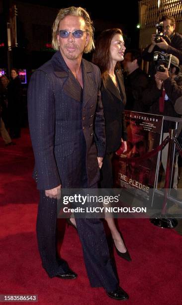 Actor Mickey Rourke and his companion model Carrie Otis arrive at the premiere of his new film "The Pledge" in Hollywood, CA 09 January 2001. AFP...
