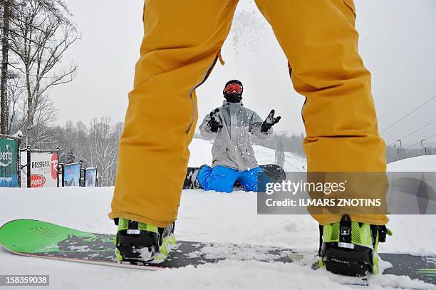 Janis Bendiks play's with snow at the top of Zagarkalns' main slope in Cesis, Latvia on December 5, 2012. In the flat Baltic nation of Latvia, where...