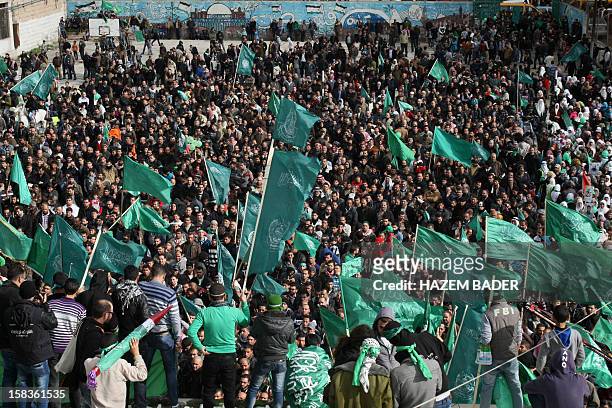 Hamas supporters take part in a rally celebrating the 25th anniversary of the founding of the Islamist mouvement on December 14 in the West Bank city...