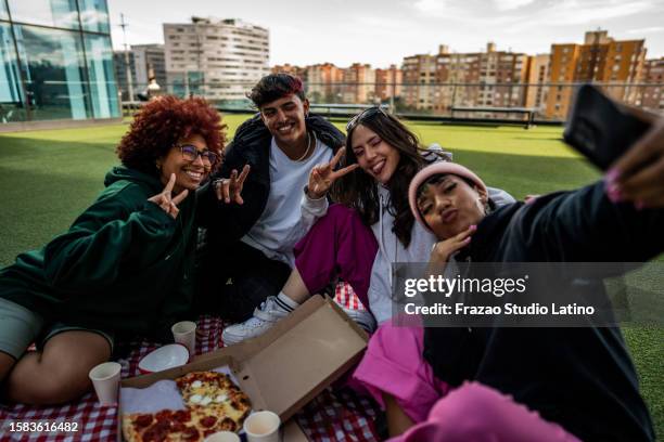 friends taking a selfie during a picnic at the rooftop - university student picnic stock pictures, royalty-free photos & images