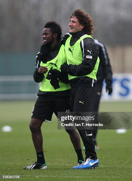 Fabricio Coloccini hugs team-mate Geal Bigirimana during a Newcastle United training session at the Little Benton training ground on December 14,...