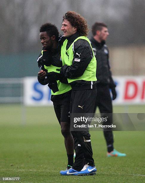 Fabricio Coloccini hugs team-mate Geal Bigirimana during a Newcastle United training session at the Little Benton training ground on December 14,...