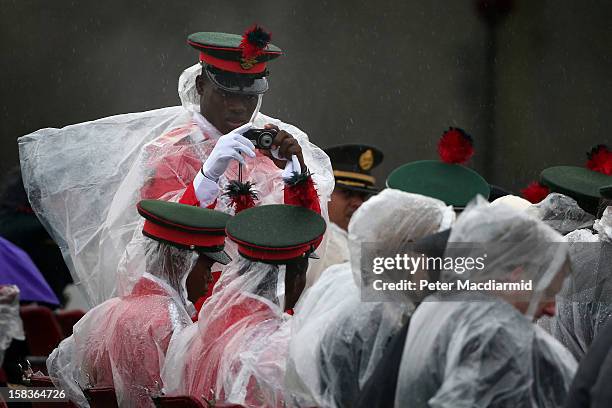 An overseas soldier takes a photograph during the Sovereign's Parade at the Royal Military Academy at Sandhurst on December 14, 2012 in England. The...