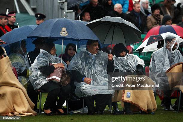 Family members watch the Sovereign's Parade in heavy rain at the Royal Military Academy at Sandhurst on December 14, 2012 in England. The parade...