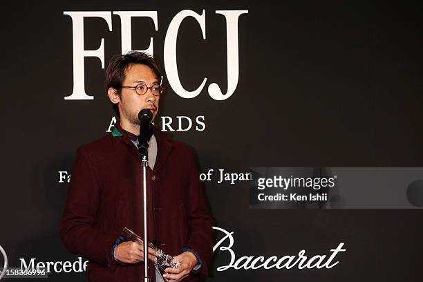 Designer Jun Takahashi of Undercover receives the Designer of the Year award during the 54th Fashion Editors Club of Japan Awards at Mercedes-Benz...