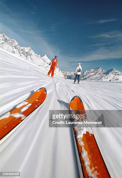 close-up of skis, following skiiers on a ski slope - ski closeup stock-fotos und bilder