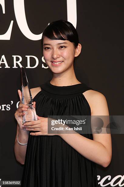 Actress Emi Takei poses with Celebrity of the Year award trophy during the 54th Fashion Editors Club of Japan Awards at Mercedes-Benz Connection on...