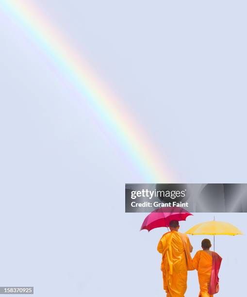 father and son walking under a rainbow - colombo stock-fotos und bilder