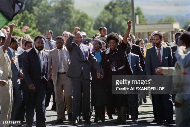 Anti-apartheid leader and African National Congress member Nelson Mandela and his wife anti-apartheid campaigner Winnie raise fists upon Mandela's...