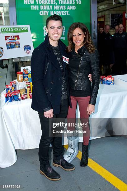 Kevin Jonas And Danielle Jonas attend City Harvest Holiday Season Food Drive at FDNY Station - Lexington & 3rd on December 14, 2012 in New York City.