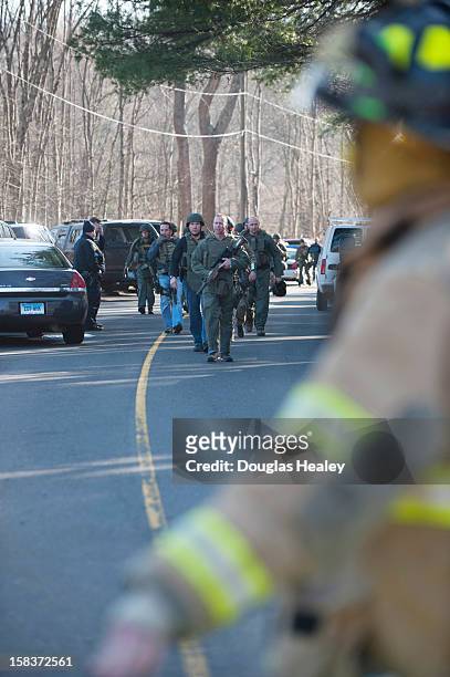 Connecticut State Police walk on Dickson Street from the scene of an elementary school shooting on December 14, 2012 in Newtown, Connecticut....