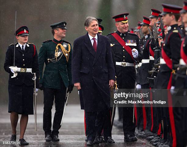 Senior Under Officer Sarah Hunter-Choat accompanies Secretary of State for Defence Philip Hammond as he inspects the Officer Cadets whilst...