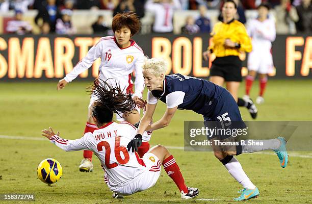 Megan Rapinoe of the U.S. Women's National Team collides with Wu Haiyan defender of the China Women's National Team and Pu Wei midfielder of the...