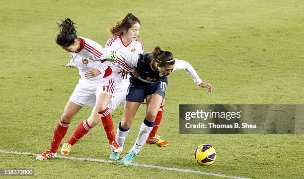 Carli Lloyd of the U.S. Women's National Team collides with Pu Wei midfielder of the China Women's National Team in an international friendly game at...