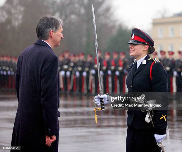 Secretary of State for Defence Philip Hammond presents Senior Under Officer Sarah Hunter-Choat with the Sword of Honour whilst representing Queen...