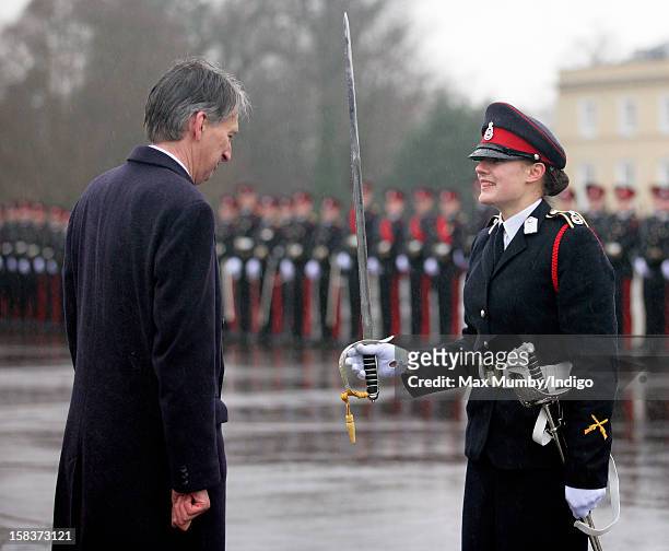 Secretary of State for Defence Philip Hammond presents Senior Under Officer Sarah Hunter-Choat with the Sword of Honour whilst representing Queen...