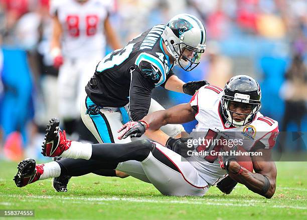 Julio Jones of the Atlanta Falcons makes a catch as Haruki Nakamura of the Carolina Panthers during play at Bank of America Stadium on December 9,...