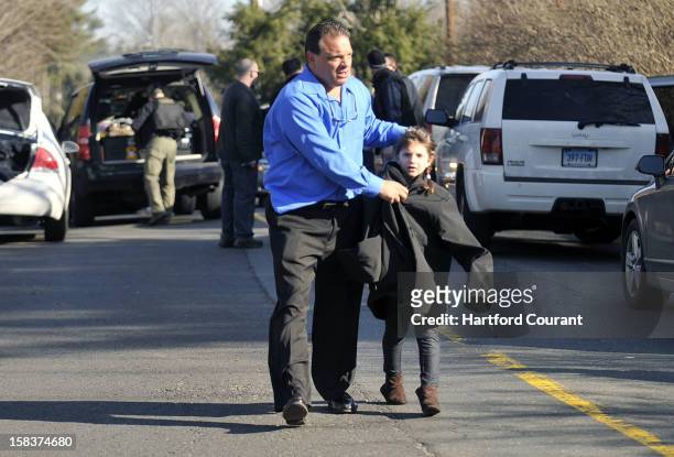 Parents leave Sandy Hook Elementary School in Newtown, Connecticut, with their children Friday, December 14, 2012. Twenty-seven people, including 18...