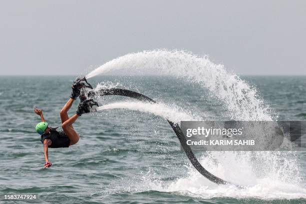 Woman practices Flyboarding off of Jumeirah beach in Dubai on August 7, 2023.