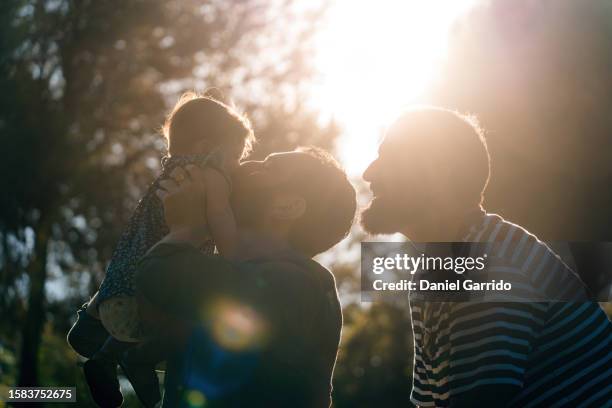 happy dads thanks to surrogacy, two dads and their cherished daughter, a dream come true. - surrogacy stock pictures, royalty-free photos & images